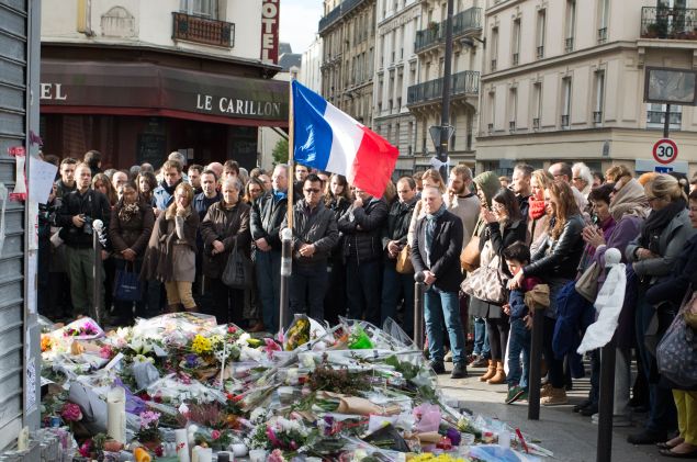PARIS, FRANCE - NOVEMBER 16: People gather to observe a minute silence outside the Le Carillon restaurant in memory of the victims of the Paris terror attacks last Friday, on November 16, 2015 in Paris, France. Countries across Europe joined France, currently observing three days of national mourning, in a one minute-silence today in an expression of solidarity with the victims of the terrorist attacks, which left at least 129 people dead and hundreds more injured. (Photo by Thierry Orban/Getty Images)
