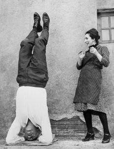 ROME, ITALY: Italian actress Valentina Cortese smiles at US actor Anthony Quinn relaxing in a yoga position 17 December 1963 in Rome, during the shooting of "The Visit" directed by Serge Miller. Born to an Irish father and Mexican mother 21 April 1915 in Chihuahua, Mexico, Anthony Quinn enjoyed a breef career as a prizefighter before entering movies in 1936. Quinn won his first Academy Award in 1952 as the brother of a Mexican revolutionary (played by Marlon Brando) in "Viva Zapata". High spots include "La Strada " (Fellini, 1954), "Lust for Life" (1956), "The Hunchback of Notre Dame" (1957)... In 1962 he contributed a vibrant performance as an amoral Bedouin chieftain in David Lean's Lawrence of Arabia. Starring an earthy Greek peasant in "Zorba the Greek" he won an Academy Award in 1964. Quinn died 03 June 2001 in Boston, USA. (FILM) AFP PHOTO (Photo credit should read AFP/AFP/Getty Images)