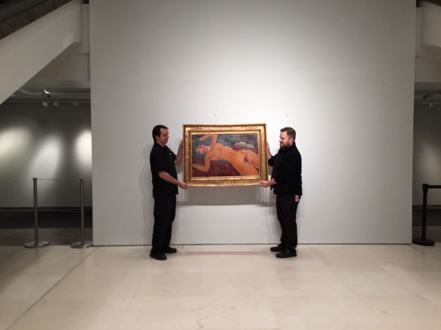 Art handlers at Christie's after Thursday evening's Impressionist and Modern Art evening sale whisking away Modigliani's recording-setting $170.4 million painting Nu Couché to its new owner Chinese billionaire Liu Yiqian. (Photo: Alanna Martinez)
