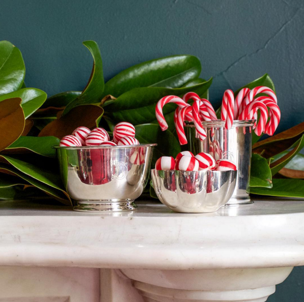 Julep cups and silver bowls make mantle decorating elegant and easy (Photo: Draper James).