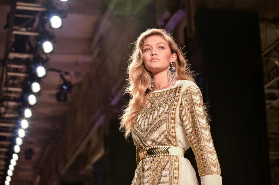 Gigi Hadid models in the H&M x Balmain runway show (Photo: Patrick McMullan). 