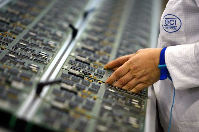 PETAH TIKVA, ISRAEL - JANUARY 15: Circuit boards are lined up by an Israeli technician along a production line at an ECI Telecom high-tech plant January 15, 2003 in Petah Tikva which is located in central Israel. ECI Telecom, which specializes in telecommunication networking solutions, is placed amongst the 10 leading companies in Israel with its sales in excess of US$1.2 billion last year and employs over 3,500 employess worldwide. (Photo by David Silverman/Getty Images)