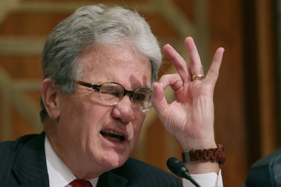 Study co-author, the former U.S. Sen. Tom Coburn (R-OK) gestures to indicate how much the federal government ought to be spending on outside PR firms. September 9, 2014 in Washington, DC. (Photo by Chip Somodevilla/Getty Images)