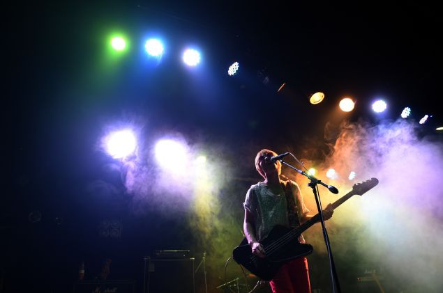 This photo taken on September 17, 2014 shows Feng Bo, bassist and singer for rock band Superbad, performing in a bar in Beijing. Beijing has a vibrant rock scene with bands performing at small bars throughout the week. AFP PHOTO/Greg BAKER (Photo credit should read GREG BAKER/AFP/Getty Images)