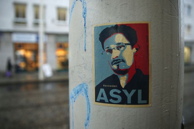DRESDEN, GERMANY - JANUARY 05: A sticker demanding asylum for whistleblower and former NSA worker Edward Snowden hangs stuck to a lamppost on January 5, 2015 in Dresden, Germany. Many Germans favour granting Snowden asylum in Germany following reports that the NSA has conducted extensive eavesrodpping operations in Germany and even listened in on the mobile phone of German Chancellor Angela Merkel. (Photo by Sean Gallup/Getty Images)