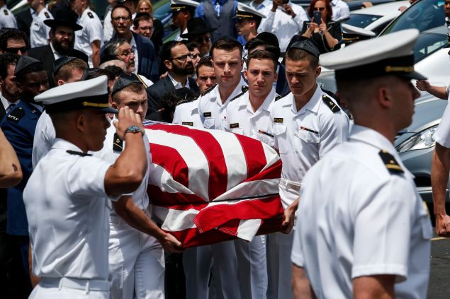 HEWLETT, NY - MAY 15: Midshipmen from the U.S Naval academy carry Midshipman Justin Zemser to a waiting car after his funeral on May 15, 2015 in Hewlett New York. Zemser was one of eight people who were killed in the derailment of an Amtrak train on May 12th in Philadelphia. (Photo by Kena Betancur/Getty Images)