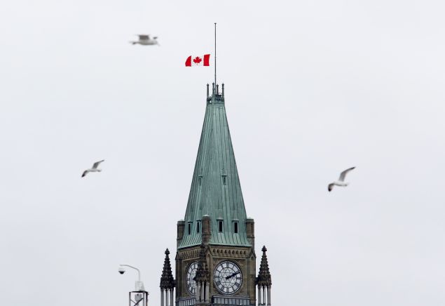 The Canadian flag flies at half-mast over the Parliament Buildings on November 14, 2015 in Ottawa, one day after the terrorist attacks in Paris. Canadian Prime Minister Justin Trudeau expressed solidarity with France after a wave of deadly attacks in Paris left at least 129 people dead. AFP PHOTO / Patrick Doyle (Photo credit should read PATRICK DOYLE/AFP/Getty Images)