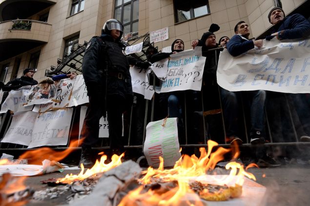 Protesters hold placards and shout slogans as they take part in an anti-Turkey picket outside the Turkish embassy in Moscow (KIRILL KUDRYAVTSEV/AFP/Getty Images)