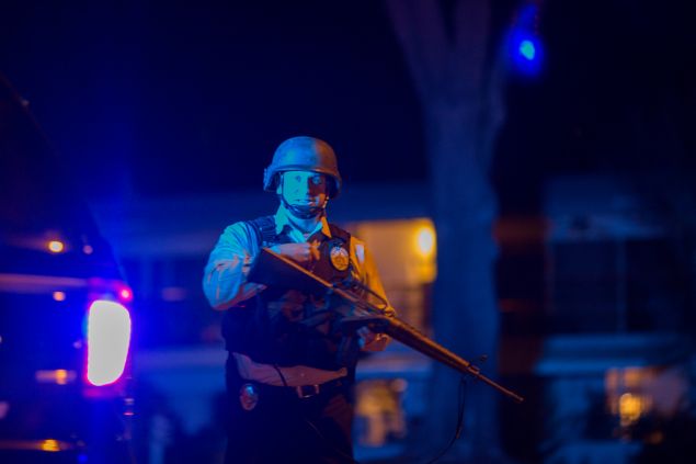 SAN BERNARDINO, CA - DECEMBER 2: A police officer officer guards a police line as officers prepare to raid the home of one or more suspects of a mass shooting at the Inland Regional Center (Photo by David McNew/Getty Images).