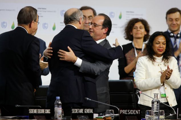 Foreign Affairs Minister and President-designate of COP21 Laurent Fabius (2-L) and France's President Francois Hollande (C) hug after the adoption of a historic global warming pact at the COP21 Climate Conference in Le Bourget, north of Paris, on December 12, 2015. Envoys from 195 nations on December 12 adopted to cheers and tears a historic accord to stop global warming, which threatens humanity with rising seas and worsening droughts, floods and storms. AFP PHOTO / FRANCOIS GUILLOT / AFP / FRANCOIS GUILLOT (Photo credit should read FRANCOIS GUILLOT/AFP/Getty Images)
