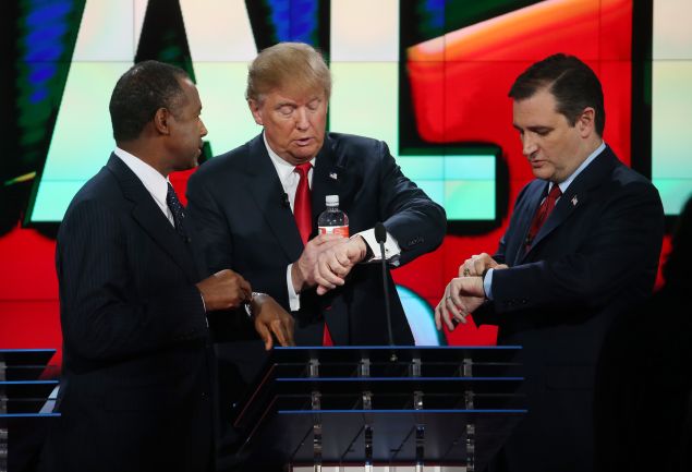 LAS VEGAS, NV - DECEMBER 15: (L to R) Republican presidential candidates Ben Carson, Donald Trump and U.S. Sen. Ted Cruz (R-TX) look at their watches during the CNN Republican presidential debate on December 15, 2015 in Las Vegas, Nevada. This is the last GOP debate of the year, with U.S. Sen. Ted Cruz (R-TX) gaining in the polls in Iowa and other early voting states and Donald Trump rising in national polls. (Photo by Justin Sullivan/Getty Images)