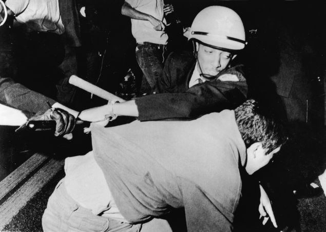 An officer from the Chicago Police Department struggles with an antiwar demonstrator outside Democratic headquarters at the Hilton Hotel on Michigan Avenue as demonstrators attempt to break through police lines to move the protest to the 1968 Democratic National Convention, being held five miles away at the International Amphitheatre, Chicago, Illinois, August 28, 1968. (Photo by APA/Getty Images)