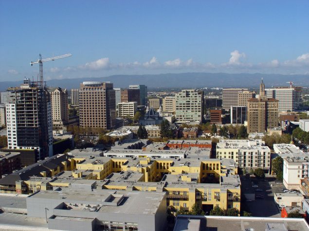 TO GO WITH AFP STORY-TECHNOLOGY-US-IT BY HELENE LABRIET-GROSS Silicon Valley's capital city San Jose, California as seen in this aerial photo is undergoing an urban development revolution calculated to keep it as the thriving heart of a region renowned for technological innovation.The city is working to reverse a trend in which promising startups take root in suburbs and neighboring cities such as Mountain View, Sunnyvale, and Cupertino -- the homes of Google, Yahoo and Apple respectively. Districts brimming with high-density housing are now blossoming near downtown office towers. There are 32,000 units in or near the city center and "enterprise incubation centers" have sprung up to nurture start-ups in the areas of software, bioscience, environment and market access. (Photo credit should read HELENE LABRIET-GROSS/AFP/Getty Images)