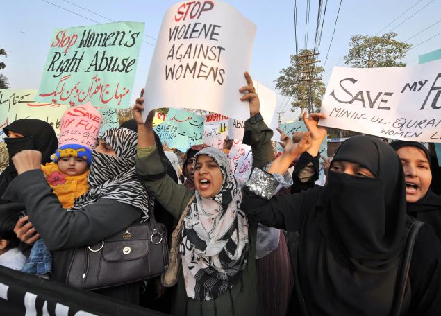 Supporters of Tehrik-e-Minhaj ul Quran, an Islamic Organisation protest against "honour killings" of women in Lahore on November 21, 2008. Human rights lawyer Zia Awan said that more than 62,000 cases of women abused in Pakistan since the year 2000 and 159 women died in honour killings in the year to September 30. AFP PHOTO/Arif ALI (Photo credit should read Arif Ali/AFP/Getty Images)