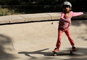 An Afghan girl rides a skateboard inside the bowl of an old concrete fountain during the celebration of International Go Skateboarding Day in Kabul on June 21, 2009. (Photo: SHAH MARAI/AFP/Getty Images)