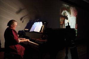 Nancy Stewart accompanied Terry Borton during a performance featuring his Magic Lanterns. (Harry Zernike for the Observer.)