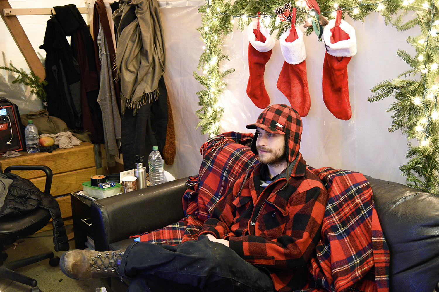 Joel Janson, 28, works the late shift selling Christmas trees on the Upper West Side. (Photo: Matthew Kassel for Observer)