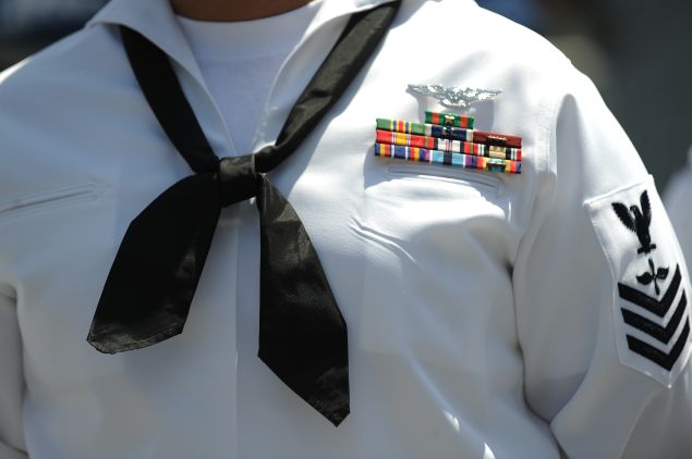 A US Navy sailor awaits the start of his re-enlistment ceremony on July 28, 2011 outside the Staples Center in downtown Los Angeles in conjunction with the Summer X-Games. Earlier this year US President Barack Obama asked the Pentagon to find $400 billion in cuts to national security but as the August 2 debt ceiling deadline approaches some members of Congress have suggested doubling that number to cut $800 billion from defense spending as part of efforts to reduce the nation's $14.3 trillion debt. AFP PHOTO / Robyn Beck (Photo credit should read ROBYN BECK/AFP/Getty Images)