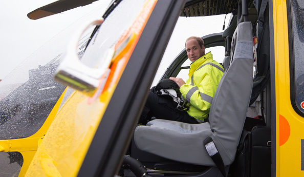 CAMBRIDGE , UNITED KINGDOM - JULY 13: Prince William, The Duke of Cambridge sits in the cockpit of an helicopter as he begins his new job with the East Anglian Air Ambulance (EAAA) at Cambridge Airport on July 13, 2015 in Cambridge, England. The former RAF search and rescue helicopter pilot will work as a co-pilot transporting patients to hospital from emergencies ranging from road accidents to heart attacks. (Photo by Stefan Rousseau WPA - Pool/Getty Images)