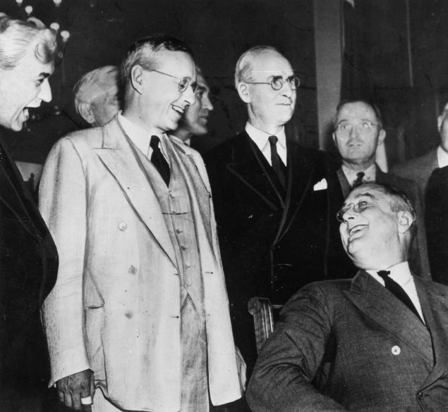 The Republican Governor of Kansas and presidential candidate, Alfred Landon (1887 - 1987) greeting the American President Franklin Delano Roosevelt (1882 - 1945) (seated) prior to the presidential elections. Future United States President Harry S. Truman can been seen in the background. (Photo by Keystone/Getty Images)