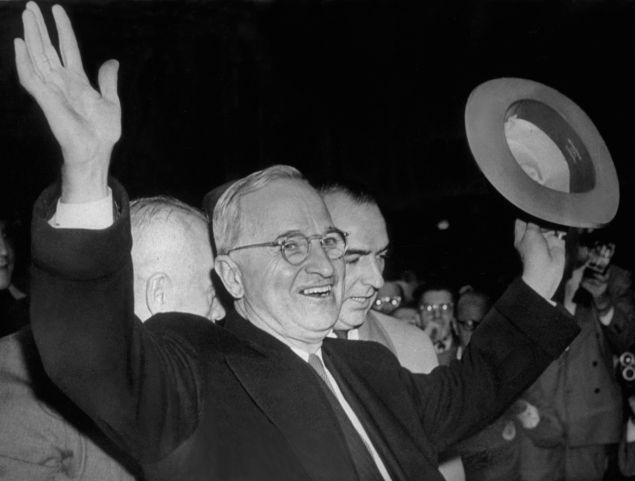 1948: American President, Harry S Truman smiles and waves to the excited Kansas City crowd after hearing the news that he had won the United States elections and retained the Presidency. (Photo by Keystone/Getty Images)