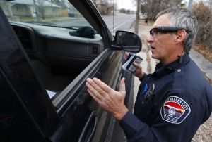 WEST VALLEY CITY, UT - MARCH 2: West Valley City patrol officer Gatrell performs a traffic stop on the first day of use of his newly-issued body camera attached to the side of a pair of glasses on March 2, 2015 in West Valley City, Utah. West Valley City Police Department has issued 190 Taser Axon Flex body cameras for all it's sworn officers to wear starting today.
