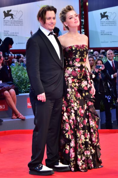 US actress Amber Heard arrives with her husband US actor Johnny Depp for the screening of the movie "The Danish Girl" presented in competition at the 72nd Venice International Film Festival on September 5, 2015 at Venice Lido. AFP PHOTO / GIUSEPPE CACACE (Photo credit should read GIUSEPPE CACACE/AFP/Getty Images)