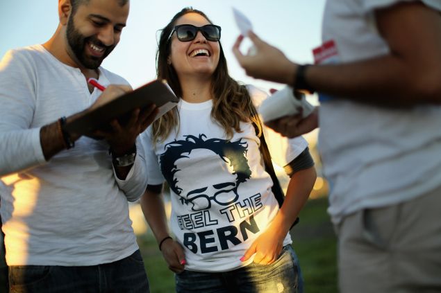 MANASSAS, VA - SEPTEMBER 14: Supporters sign a petition to get Democratic presidential candidate Sen. Bernie Sanders (I-VT) on the ballot in Virginia during a campaign rally at the Prince William County Fairground September 14, 2015 in Manassas, Virginia. Sanders addressed 12,000 students at Christian Liberty University earlier in the day. (Photo by Chip Somodevilla/Getty Images)