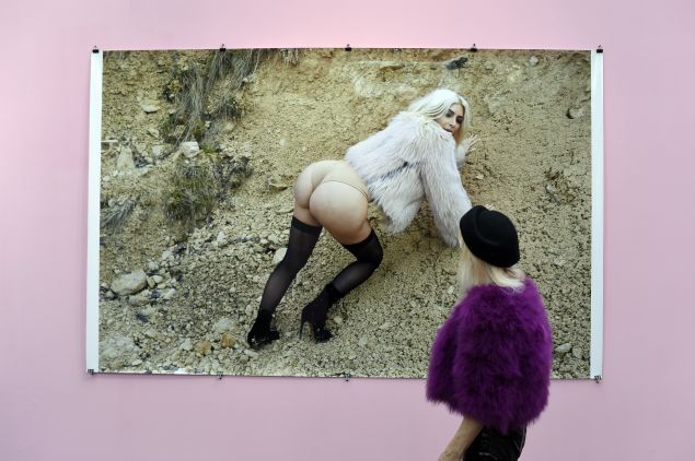 A visitor watches a photo of reality television star Kim Kardashian by German photographer Juergen Teller during the opening of the 19th edition of the Paris Photo Fair, the international fina art photography event that hosts leading galleries and artbook dealers, at the Grand Palais in Paris on November 11, 2015. The fair runs through November 12-15. AFP PHOTO/MIGUEL MEDINA == RESTRICTED TO EDITORIAL USE, MANDATORY MENTION OF THE ARTIST UPON PUBLICATION, TO ILLUSTRATE THE EVENT AS SPECIFIED IN THE CAPTION == (Photo credit should read MIGUEL MEDINA/AFP/Getty Images)