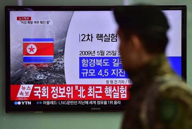 CORRECTION - YEAR A South Korean soldier walks past a television display showing a news report at a railroad station in Seoul on January 6, 2016, after seismologists detected a 5.1 magnitude tremor next to North Korea's main atomic test site in the northeast of the country. North Korea said on January 6 it had successfully carried out its first hydrogen bomb test, marking a major step forward in its nuclear development if confirmed. AFP PHOTO / JUNG YEON-JE / AFP / JUNG YEON-JE (Photo credit should read JUNG YEON-JE/AFP/Getty Images)