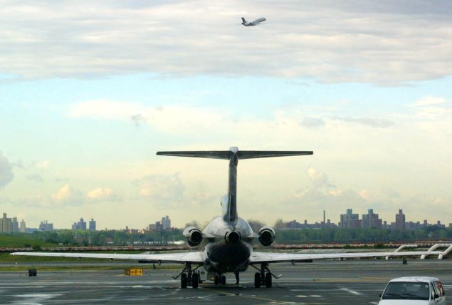 NEW YORK, UNITED STATES: An airplane readies to taxi while another takes off at LaGuardia Airport in New York 14 September 2001. The airport reopened 14 September 2001 three days after the terrorist attacks on US soil. AFP PHOTO/Doug KANTER (Photo credit should read DOUG KANTER/AFP/Getty Images)