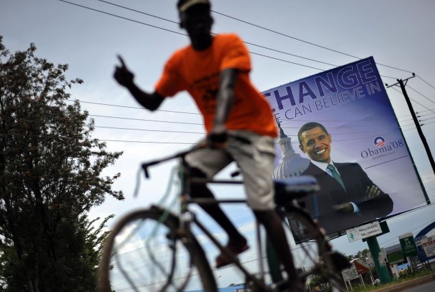 A Kisumu resident raises his index finger to signify 'winner' as he cycles November 02, 2008 past a billboard of US Democratic presidential hopeful Barak Obama now commonly refered to as 'son of Kenya' at the Obama's rural home in Siaya district. Excitement continues to mount in Kisumu, the headquarter of Kenya's Western province as the 'Son of Kenya', a term increasingly used to refer to Barak given his fathers Kenyan origins, as Obama continues to lead his main rival, Republican John McCain in preliminary polls two days to the historic vote. AFP PHOTO/Tony KARUMBA (Photo credit should read TONY KARUMBA/AFP/Getty Images)