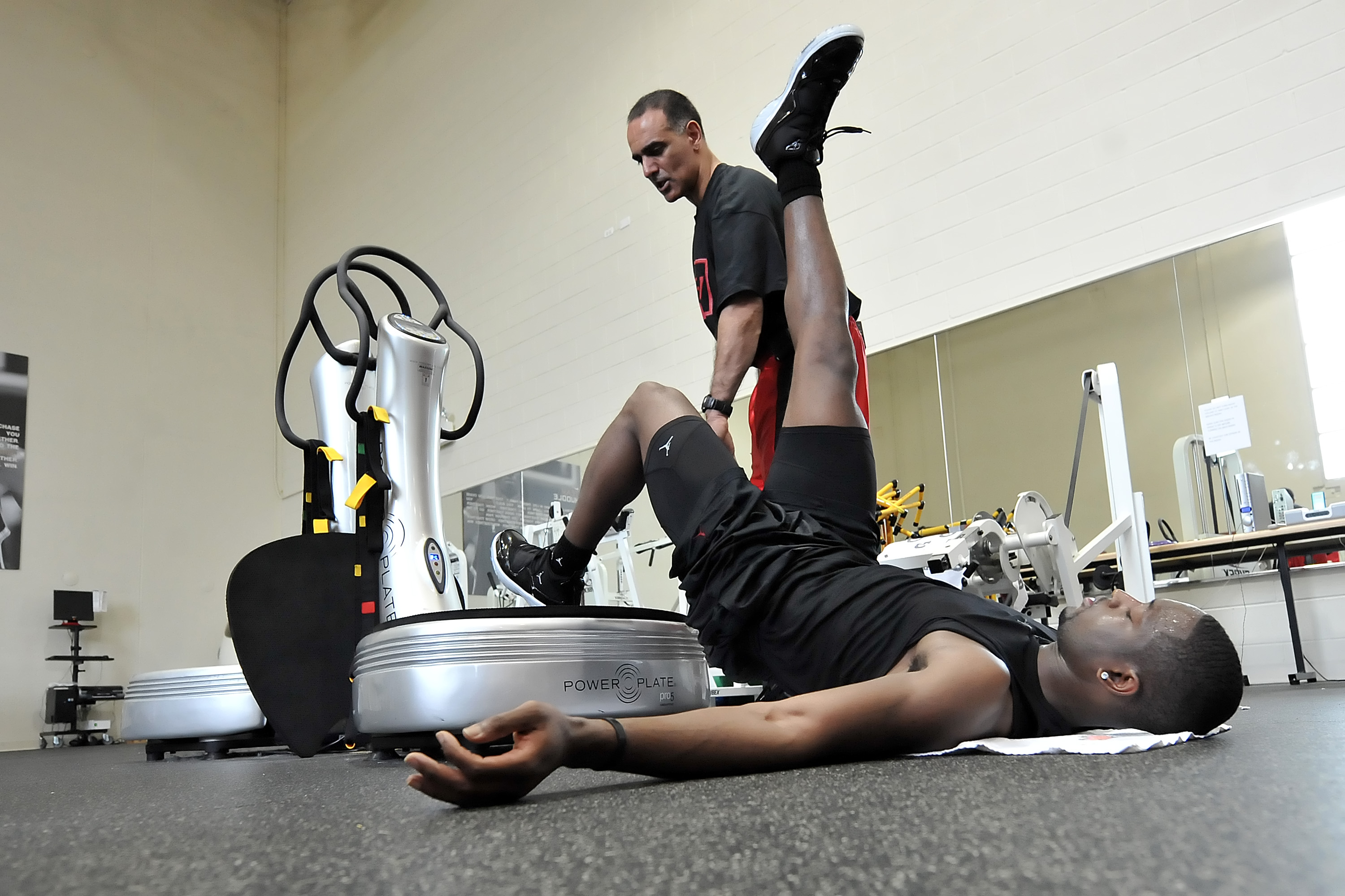 CHICAGO - SEPTEMBER 8: Dwyane Wade (R) of the Miami Heat uses a Power Plate machine help from Tim Grover, sports performance enhancement specialist and ATTACK Athletics owner, during his workout on September 8, 2009 at ATTACK Athletics in Chicago, Illinois. NOTE TO USER: User expressly acknowledges and agrees that, by downloading and/or using this photograph, user is consenting to the terms and conditions of the Getty Images License Agreement. Mandatory Copyright Notice: Copyright 2009 NBAE (Photo by Randy Belice/NBAE via Getty Images)