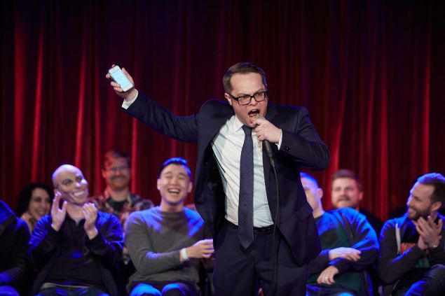 Fifty First Jokes, hosted by comic John F. O'Donnell, at The Bell House in Brooklyn, January 2nd, 2016. John F. O'Donnell during his opening monologue, with the first round of 25 comics on stage behind him. PHOTO: Harry Zernike for Observer