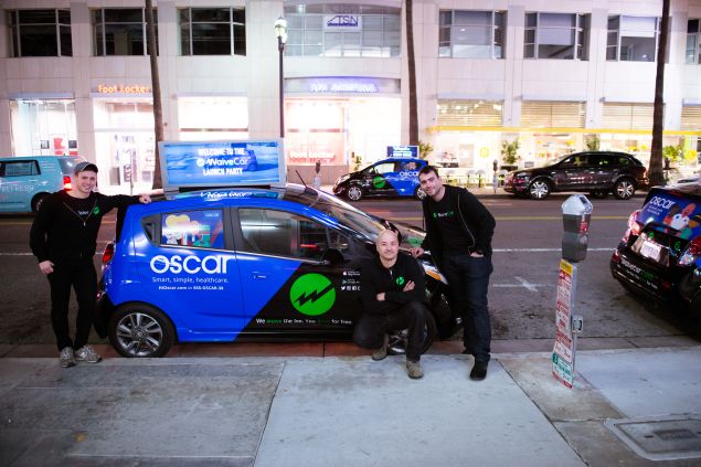 WaiveCar's founders pose with one of the company's electric cars. (Photo: WaiveCar)