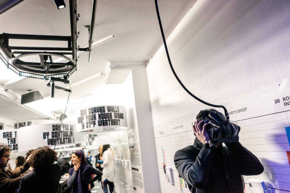 A guest at the opening of "Closed Worlds," experiencing Farzin Farzin's virtual reality work, Some World Games.
