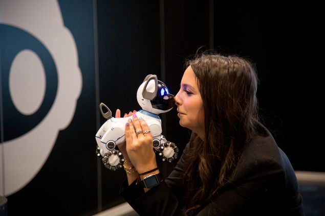 Sydney Wiseman of WowWee USA, holds CHiP's robotic dog.