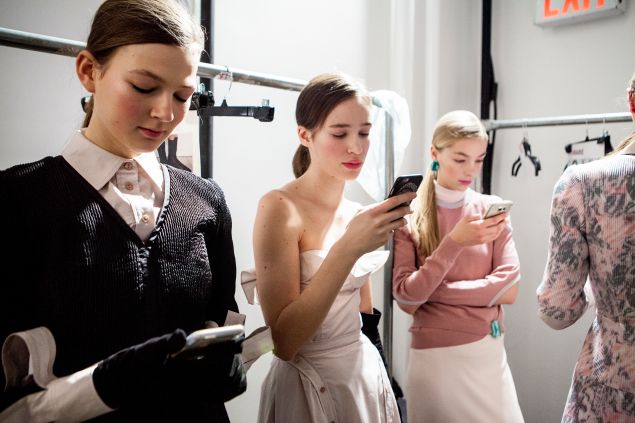 Models texting in their Gelinas creations