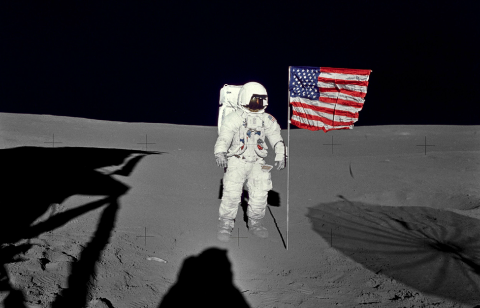 Astronaut Edgar Mitchell, Apollo 14 lunar module pilot stands by the U.S. flag on the lunar surface during the early moments of the mission's first spacewalk. (Credit: NASA)