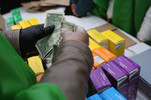 NEW YORK, NY - FEBRUARY 08: MOney is collected as Girl Scouts sell cookies while a winter storm moves in on February 8, 2013 in New York City. The scouts did brisk business, setting up shop in locations around Midtown Manhattan on National Girl Scout Cookie Day. (Photo by John Moore/Getty Images)