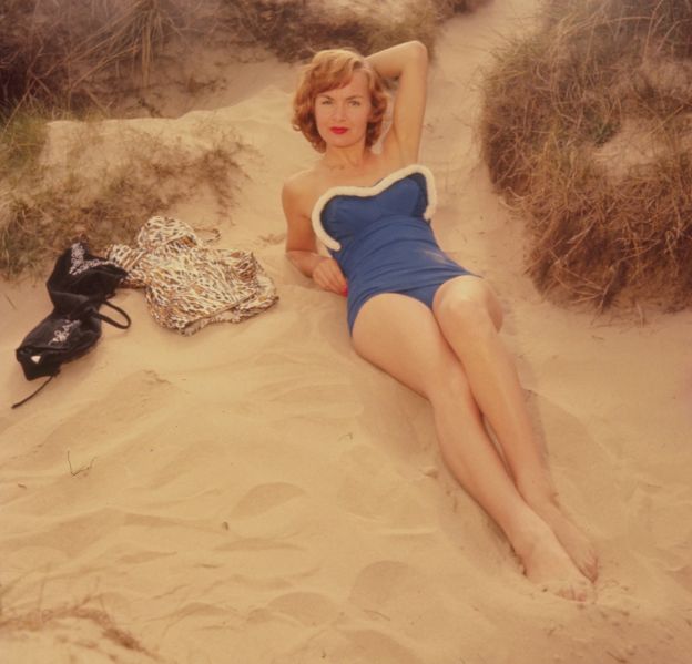 German actress Marianne Brauns, on a beach modelling a swimming costume. 