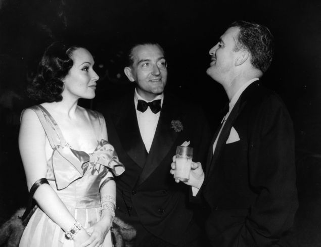 circa 1928: Actress Dolores Del Rio with her art director husband Cedric Gibbons, and Fritz Lang at the Rathbone party. Cedric designed the Oscar statuette for the Academy Awards.