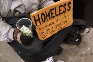NEW YORK, NY - DECEMBER 04: A person in economic difficulty holds a homemade sign asking for money along a Manhattan street on December 4, 2013 in New York City. According to a recent study by the by the United States Department of Housing and Urban Development, New York City's homeless population increased by 13 percent at the beginning of this year. Despite an improving local economy, as of last January an estimated 64,060 homeless people were in shelters and on the street in New York. Only Los Angeles had a larger percentage increase than New York for large cities. (Photo by Spencer Platt/Getty Images)