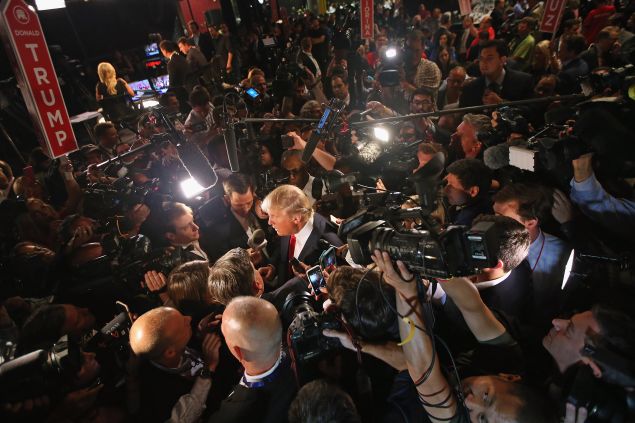 Republican presidential candidate Donald Trump talks to reporters in the 'Spin Alley' after the first prime-time presidential debate hosted by FOX News and Facebook at the Quicken Loans Arena August 6, 2015 in Cleveland, Ohio.