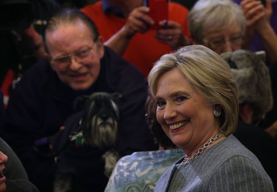 DES MOINES, IA - JANUARY 31: Democratic presidential candidate former Secretary of State Hillary Clinton greets a supporter with a dog during a "get out to caucus" event at Abraham Lincoln High School on January 31, 2016 in Des Moines, Iowa. With one day to go before the Iowa caucuses, Hillary Clinton continues to campaign throughout Iowa. (Photo by Justin Sullivan/Getty Images)