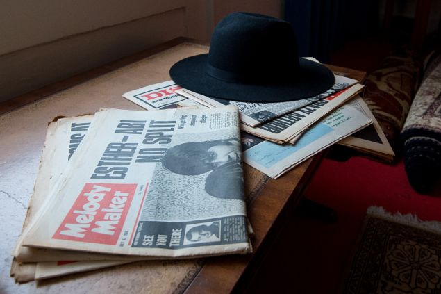 A selection of newspapers and hat is displayed in a recreation of Jimi Hendrix's bedroom.