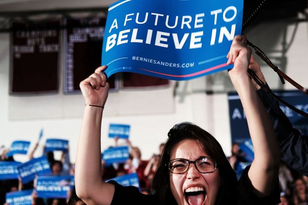 CONCORD, NH - FEBRUARY 09: People cheer as Democratic presidential candidate Sen. Bernie Sanders (D-VT) speaks onstage after victory over Hillary Clinton in the New Hampshire primary on February 9, 2016 in Concord, New Hampshire. Sanders was projected Democratic winner shortly after the polls closed. (Photo by Spencer Platt/Getty Images)