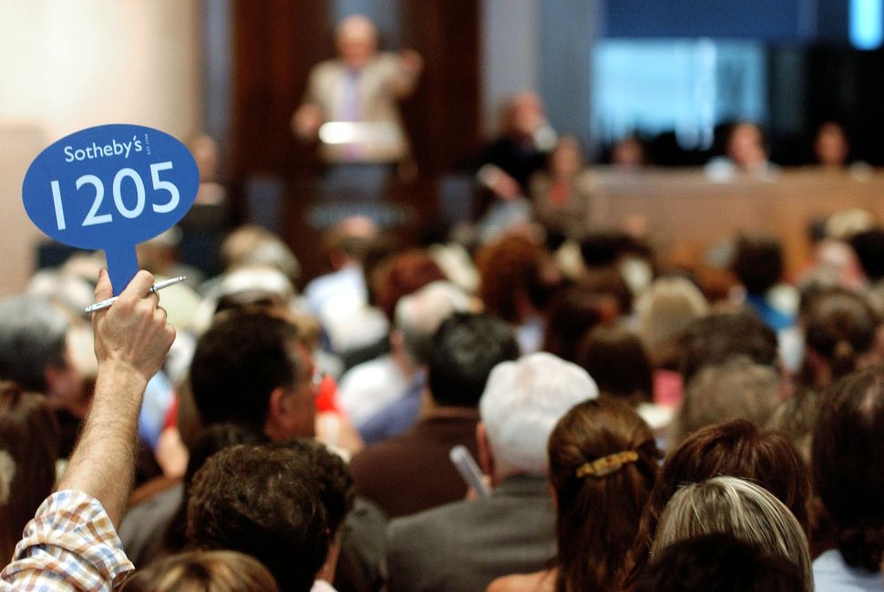 NEW YORK - JUNE 10: A bidder holds up his bidding sign during the Katharine Hepburn auction at Sotheby's June 10, 2004 in New York City. Property from the estate of the late actress Katharine Hepburn is being offered at auction and sales are expected to exceed $1 million. (Photo by Stephen Chernin/Getty Images)