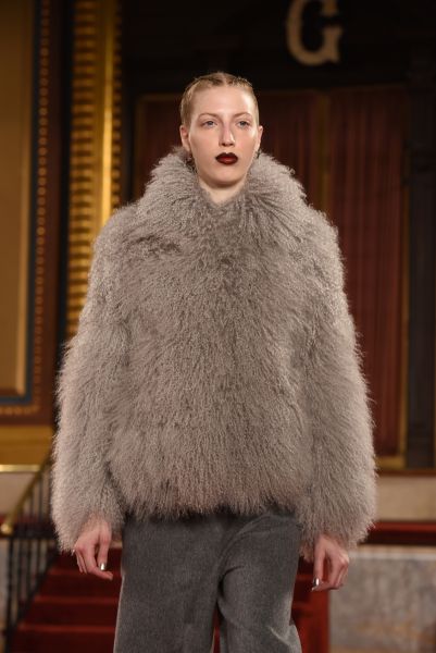 A grey Mongolian coat plays well with a bold lip (Photo: Noam Galai/Getty Images).
