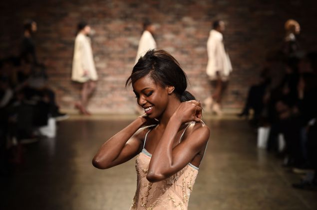 A model smiling on the runway